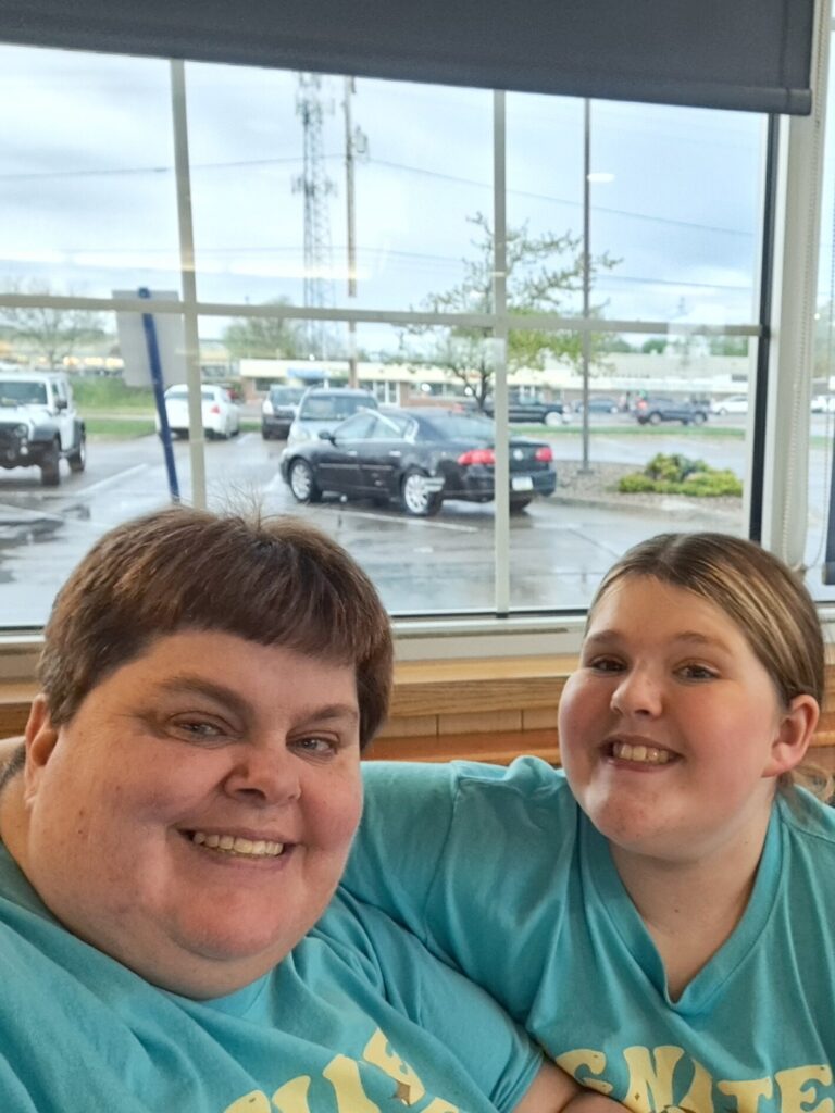 Heather Bartlett and her daughter smile for a selfie.