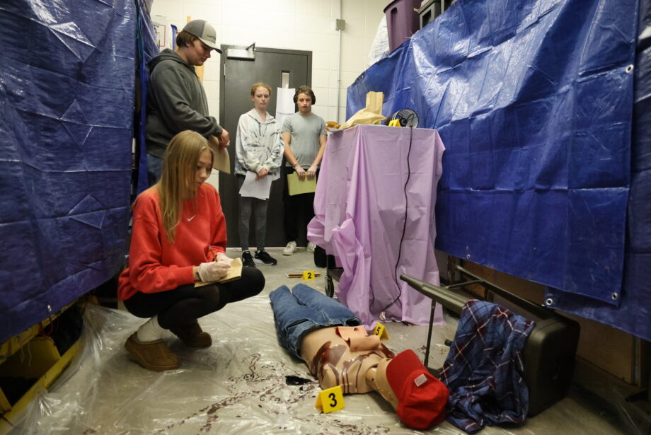 Students in Brian Carper’s Advanced Public Safety class investigate a mock crime scene April 16 at Burlington High School.