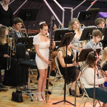 A student plays a contra-alto clarinet during a concert band concert at Memorial Auditorium