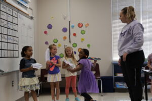 STEM teacher Jessica Dow looks on as a kindergartner launches her paper airplane Friday, Sept. 14, 2023, at Sunnyside Elementary School.