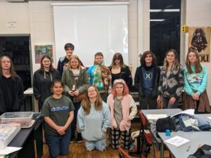 Students in VAAP pose for a photo alongside their club advisor