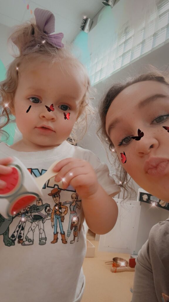 Allison Ford and her daughter pose for a selfie with a butterfly filter