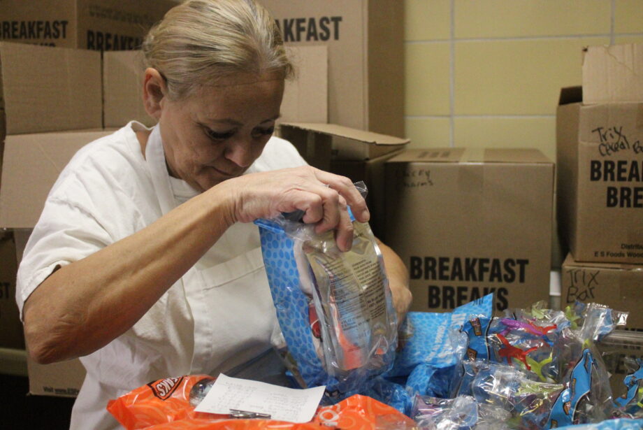 Dottie Huss packs up breakfast kits Tuesday, Feb. 21, 2023, in the kitchen at Burlington High School. Huss has been working in food service for the district for 30 years.