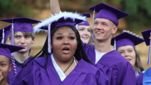 Members of the Burlington High School Class of 2023 wave to family and friends sitting in the stands Saturday, June 3, 2023, during their commencement ceremony at Bracewell Stadium.