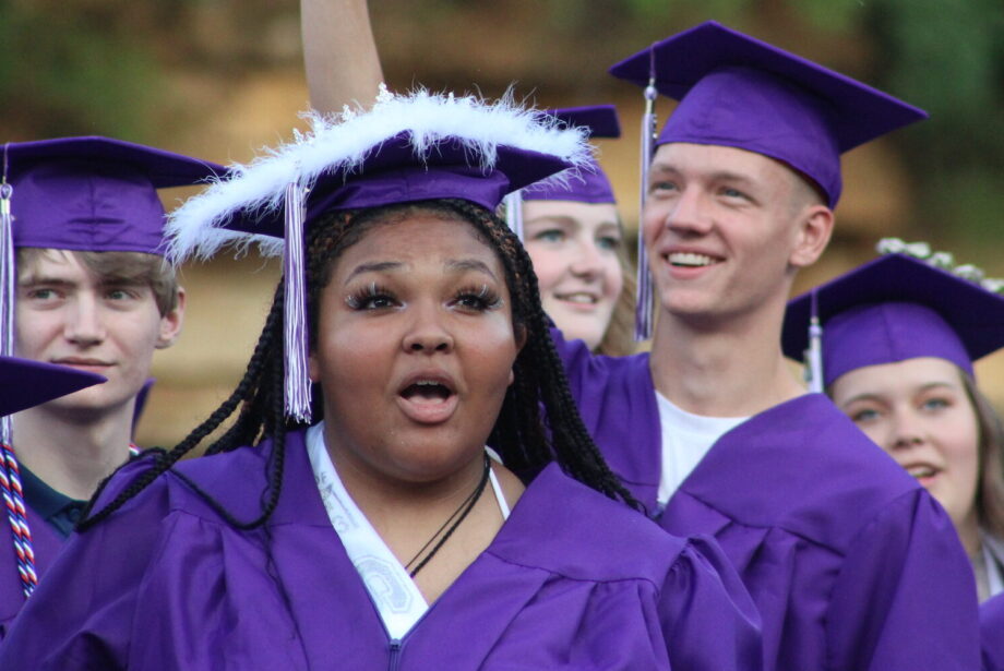 Members of the Burlington High School Class of 2023 wave to family and friends sitting in the stands Saturday, June 3, 2023, during their commencement ceremony at Bracewell Stadium.