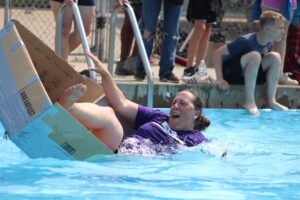 April Anderson slowly sinks into the swimming pool as her boat capsizes June 15, 2023, at Camp Eastman in Nauvoo, Illinois.