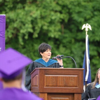 BHS Principal Monic Myers speaks into a microphone while standing behind a podium