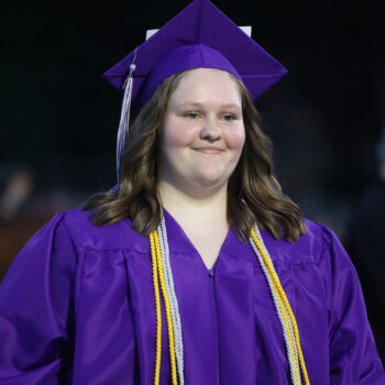 A graduate returns to her seat after accepting her diploma during the 2024 Commencement Ceremony at Bracewell Stadium.