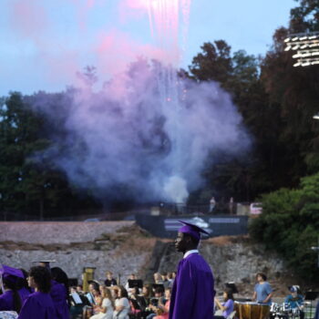 Fireworks shoot into the sky as graduates make their way toward Clark Field House following the 2024 commencement ceremony at Bracewell Stadium.