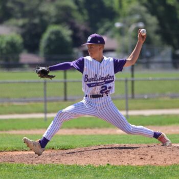 A pitcher readies to release a pitch on the pitcher's mound during a baseball game.