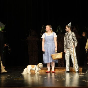 Toto, Dorothy, the Tinman and Scarecrow confront the Wicked Witch of the West on stage during the high school musical production of 