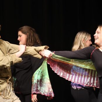 Scarecrow and a jitterbug dance onstage during the high school musical production of 