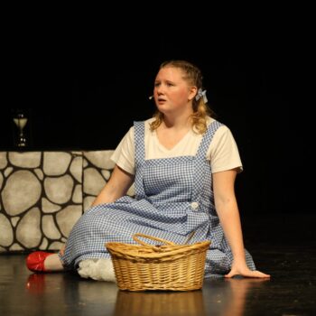 Dorothy sings while seated onstage during the high school musical production of 