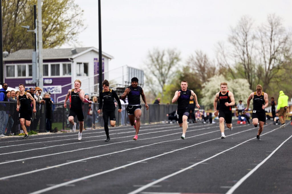 Members of the boys track and field team compete against neighboring schools in a sprint.
