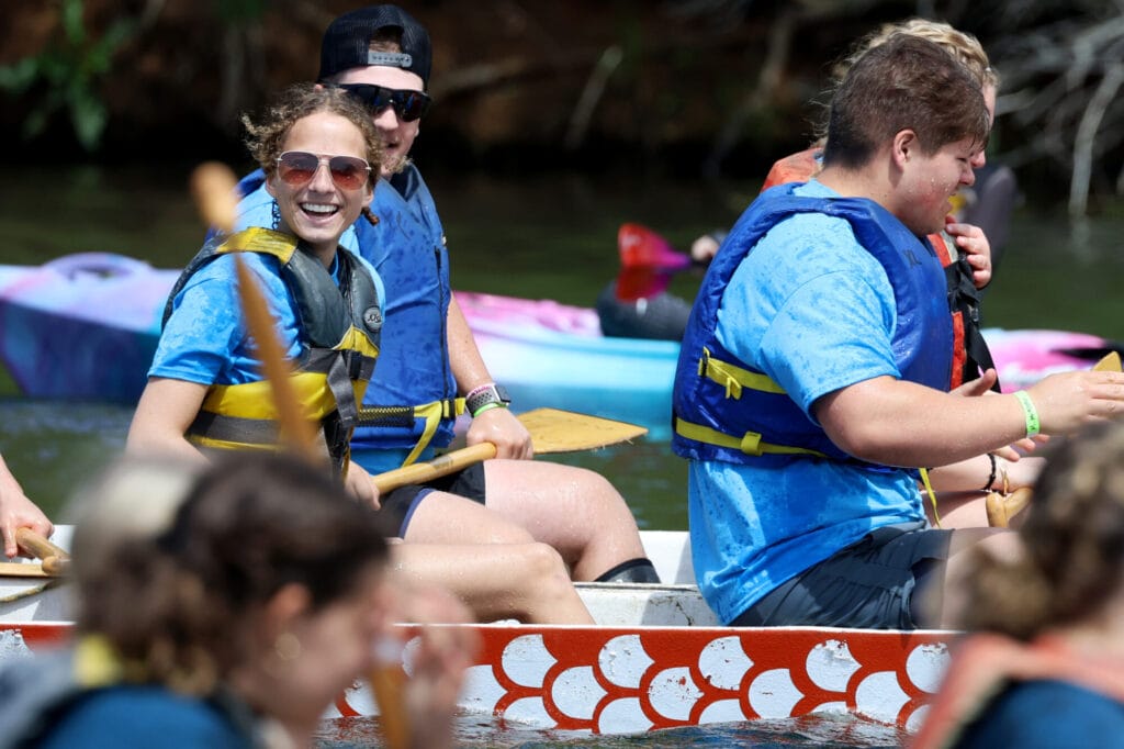 A student and her teammates smile following a race while aboard a dragon boat Sunday, May 4, 2025, during the 35th annual Dragon Boat Races at Lake Geode in Danville.